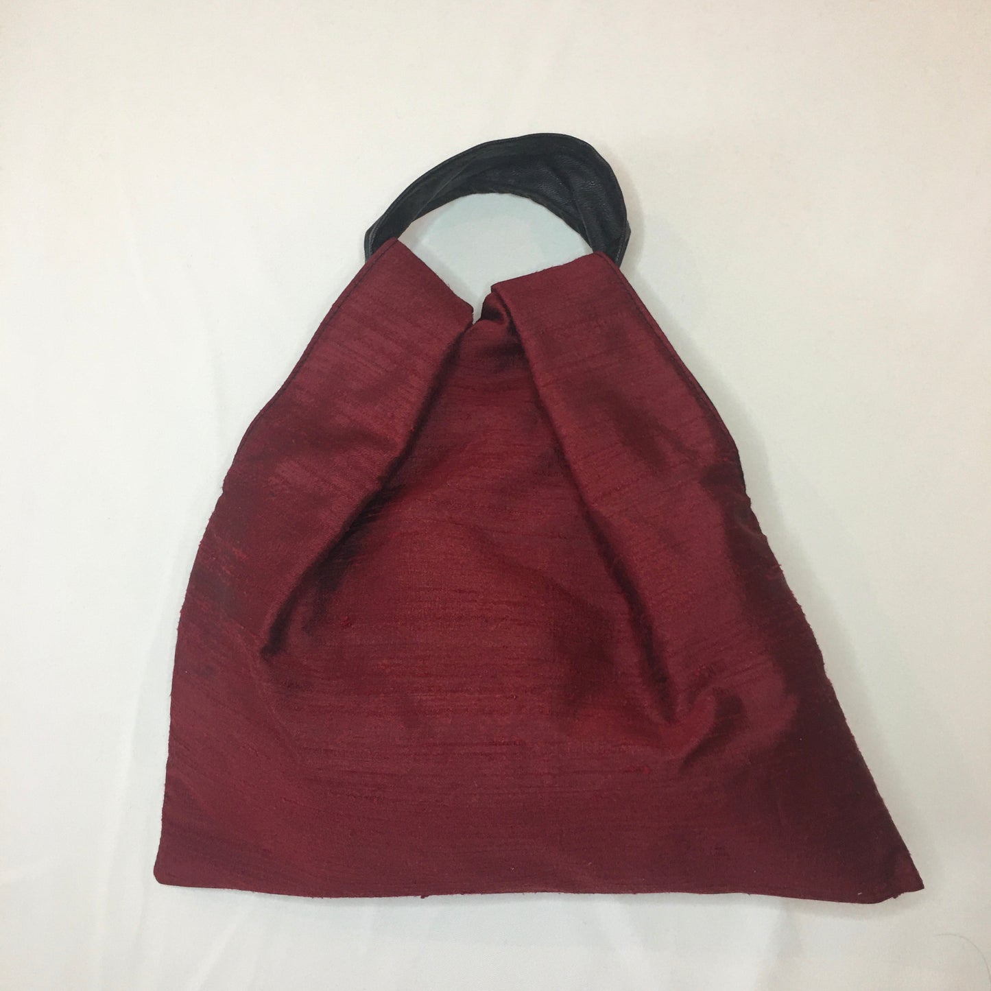 Red shantung silk lined in black leatherette