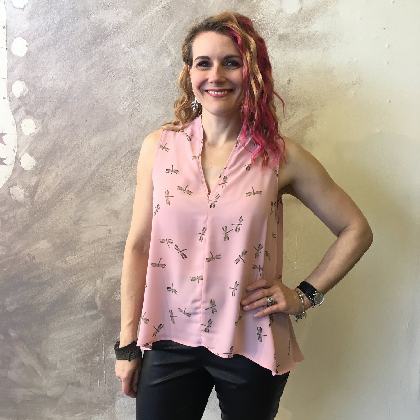 Model wears pink dragonfly print Empress top in size small and is 5'5" tall