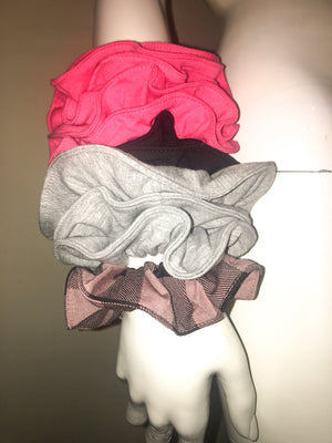 Stack of pink, black, grey and rose/black check scrunchies