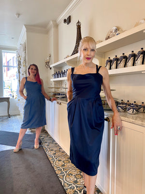 Two models stand  leaning against the counter at Cafe Crystal in Barrhaven. One wears denim Tencel  and the other midnight stretch sateen Tencel Lindon dresses