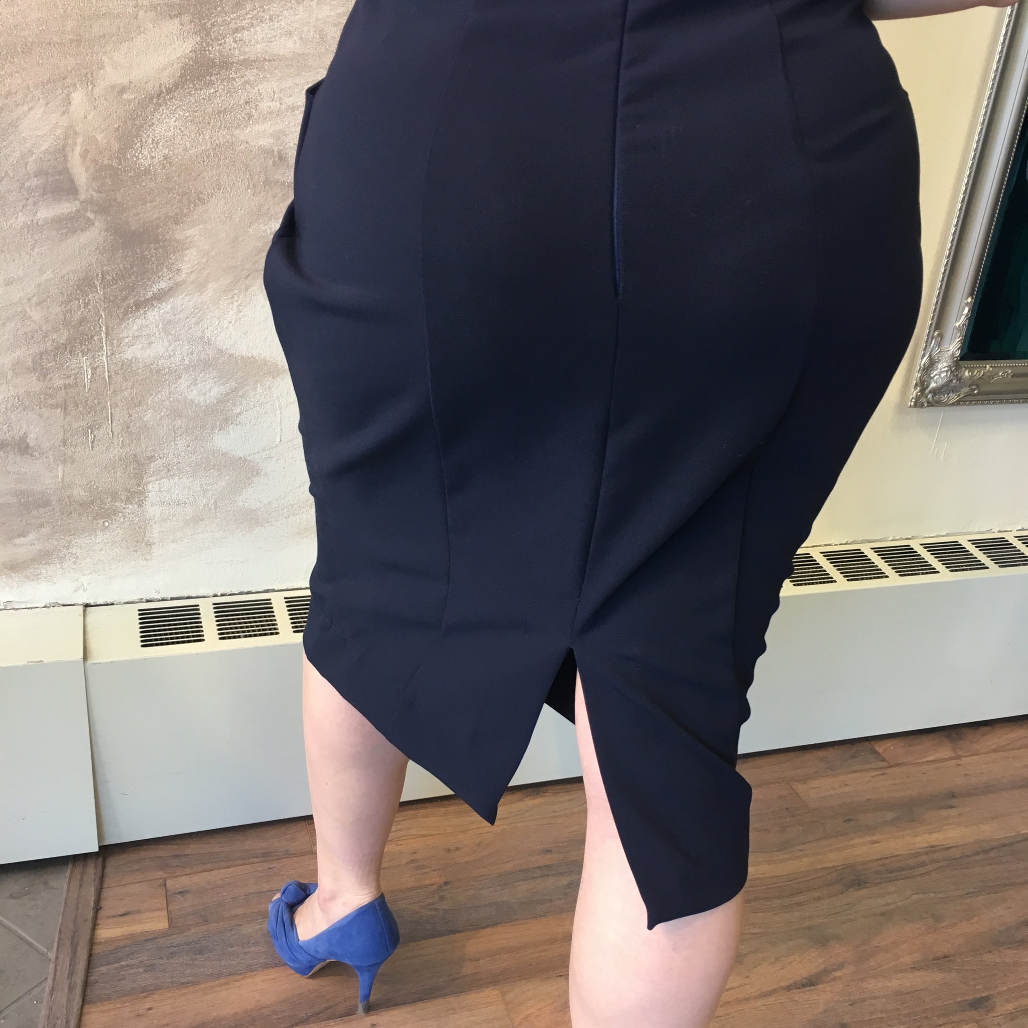 Model wears navy Vere skirt in L with M Think Tank. She is 5'8" tall. Back view of seaming and slit.