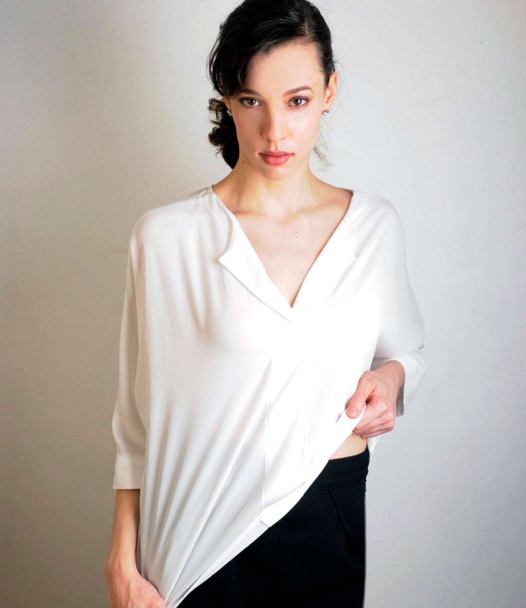 Model wears Bella blouse in white  in an oversized L for her small frame. She is 5'11' tall